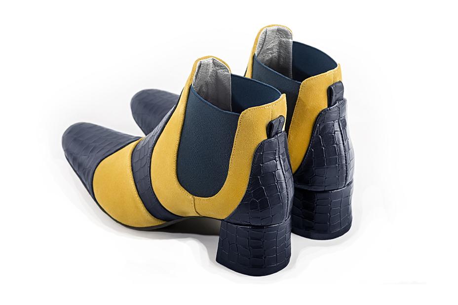 Women's navy blue and yellow elegant two-tone Chelsea ankle boots, with side elastics. Round toe. Low flare heels - Rear view